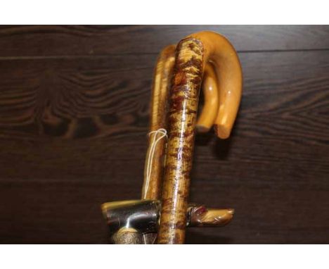 THREE VINTAGE WALKING STICKS
including one with a horn handle modelled in the form of a dog's head