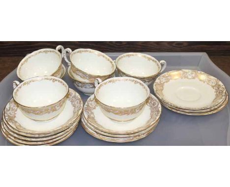 ROYAL WORCESTER TEA SERVICE
c. 1931, decorated with gilt scrolling motifs, approximately 33 pieces, the cake plate 32cm long;