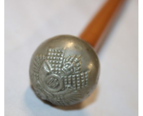 An ordinary ranks swagger stick with nickel-plated top depicting a badge of the Highland Light Infantry 