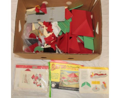 A selection of Bayko construction parts including roofs, floors, bricks, instruction books, etc
