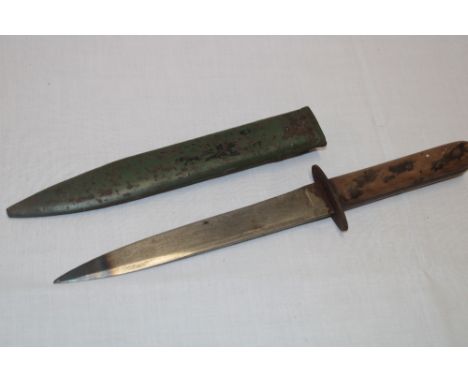 A First War German trench fighting dagger with 8" single edged blade and wooden grips in painted steel scabbard 