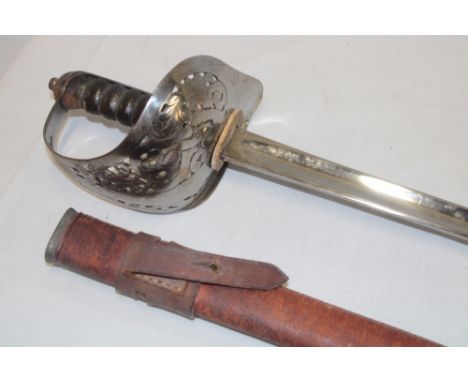 A Victorian Warrant Officer's sword with plain steel blade, steel guard and leather grip in leather scabbard 