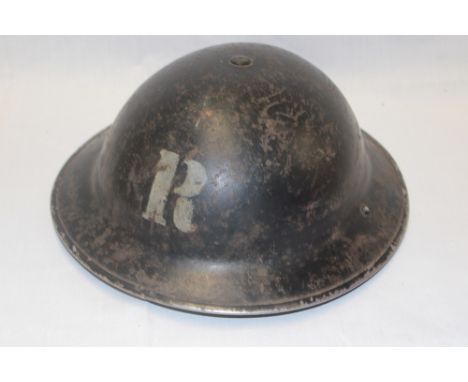 A Second War Home Service steel helmet dated 1939 marked " R" for rescue parties complete with liner and chin-strap