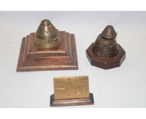 A First War shell head inkwell on wooden base "This inkwell stand is made from piece of German gas shell, the oak base was a 