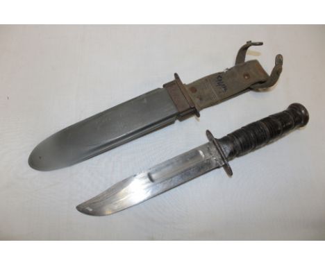 A United States Navy MK2 survival knife with 7" single edged blade, leather grip and composition scabbard marked "Nord-8114 B