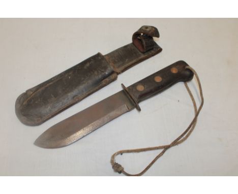 A post-war Wilkinson survival knife with 7¼" single edged blade in leather sheath 