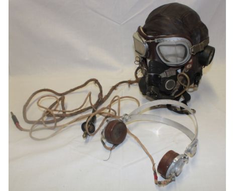 A Second War leather flying helmet, type C, named to F S Stringer together with a post-war oxygen mask, goggles and radio hea
