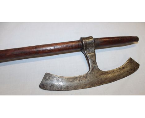 An African tribal hand axe with 7" curved steel blade and wooden shaft 