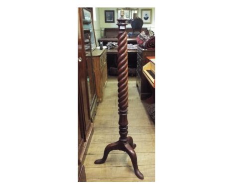 A mahogany standard lamp, on a tripod base