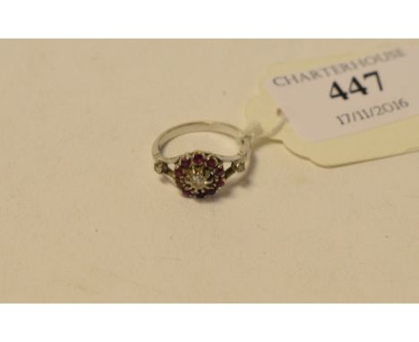 An 18ct white gold, ruby and diamond cluster ring, approx. ring size J½