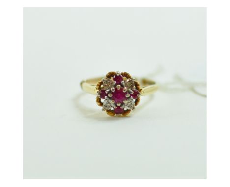 An 18ct gold, ruby and diamond cluster ring, approx. ring size L½