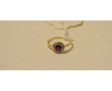 A ruby and diamond cluster ring, in a yellow coloured metal mount, approx. ring size K½