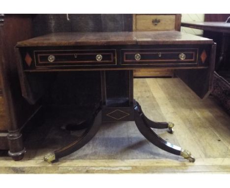 A rosewood and coromandel sofa table, with inlaid decoration, on splay legs with paw casters, 145 cm wide Condition report Re