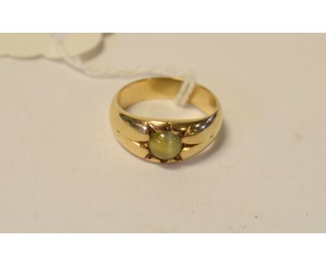 A yellow coloured metal and cat's eye chrysoberyl ring, approx. ring size K½ Condition report Report by MWSize L.  No visible