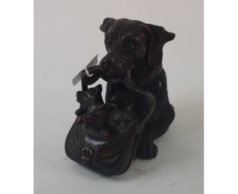 A novelty carved wood inkwell, in the form of a dog carrying its offspring in a satchel, 13 cm high