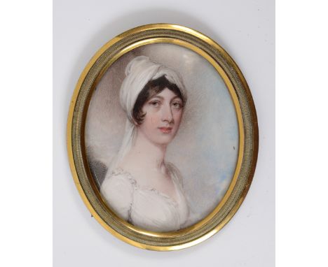 An oval bust portrait miniature, of a lady wearing a white headdress, watercolour on ivory, the reversed inscribed Zaag by Wi