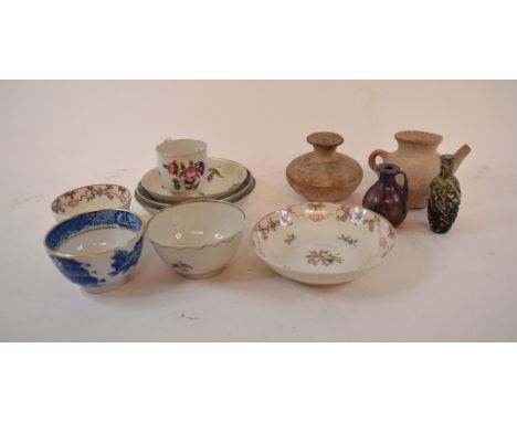 An English porcelain cup and saucer, painted floral sprays, three tea bowls and saucers, two Roman type glass vessels, an ear