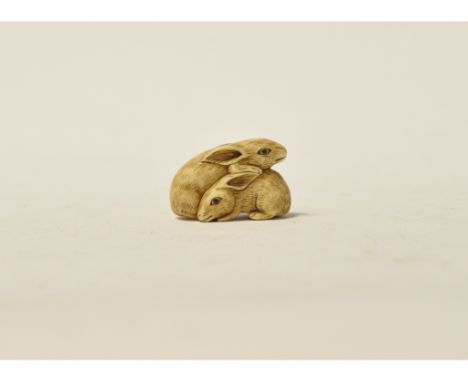 An early 20th century carved ivory netsuke, in the form of two rabbits, 2.5 cm high Condition report Report by GHSome light w