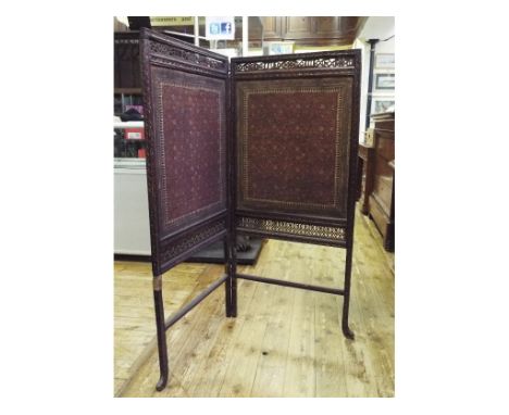 An Indian carved wood two fold screen, with tapestry panels, 124 cm high