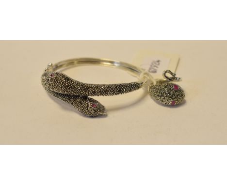 A silver, marcasite and ruby snake bangle, with a ring