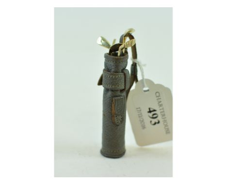 A novelty 9ct gold manicure set, in the form of golf clubs, in a leather caddy