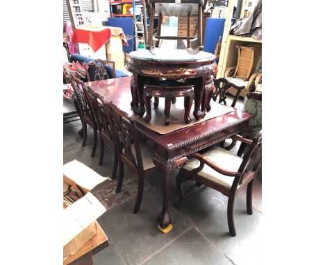 A large mahognay reproduction dining table with 8 chippendale style chairs 