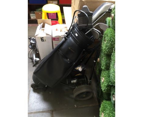 A power caddy golf trolley with battery and charger together with a bag of various golf clubs. 