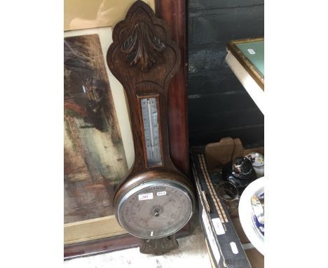 An oak aneroid barometer with steel dial. 