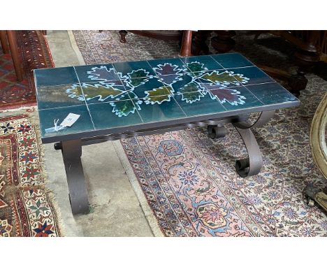 A 1970's wrought iron tile top coffee table, length 90cm, depth 45m, height 42cm