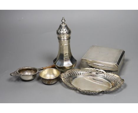 A George V engine turned silver mounted cigarette box, a similar sugar caster and later silver tea strainer and small dish.