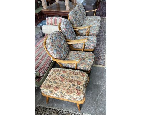 An Ercol beech three piece lounge suite and footstool, settee length 174cm, width 80cm, height 82cm