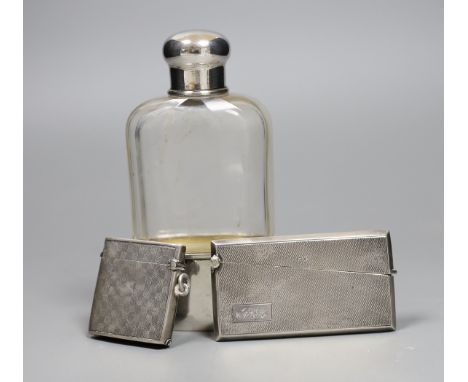 A German 800 standard white metal mounted glass hip flask, 14cm, a George V silver vesta case and a 1920's engine turned silv