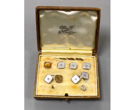 An early to mid 20th century part set of 18ct &amp; 9ct, mother of pearl and diamond set octagonal dress stud set (a.f.), in 