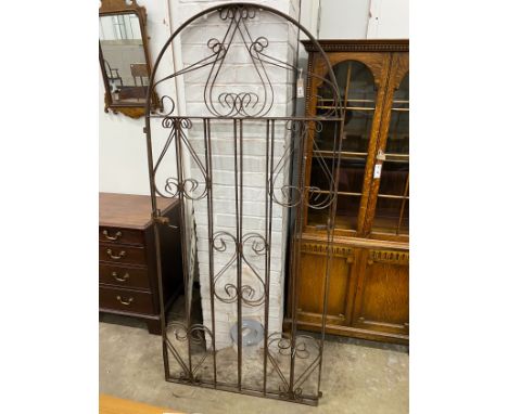 A pair of arched wrought iron gates, each gate width 85cm, height 187cm