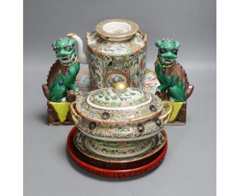 A Cantonese famille rose plate and teapot with cover, a pair of Chinese seated dogs, and a tureen with cover and oval dish, A