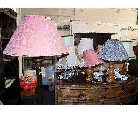 A standard lamp twinned with seven table lamps with shades. Provenance: From Trematon Hall, Saltash