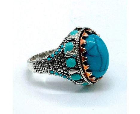 Silver tone ring with a faux turquoise cabochon center and enamel detailing. Size 13.25. Condition: Age related wear.