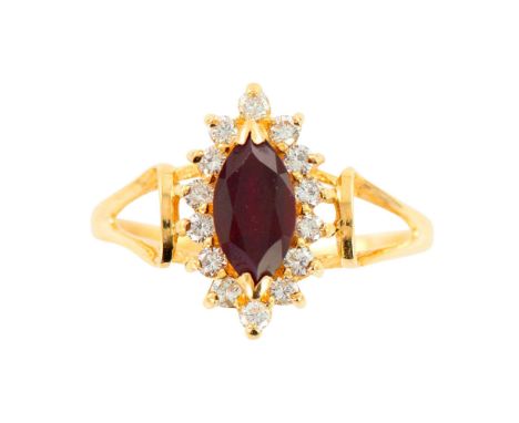 Marquise cut Rhodolite surrounded by diamonds.1.55 cts. Garnet (Rhodolite) measures 9mm X 5mm. 14 Round Brilliant Diamonds .2
