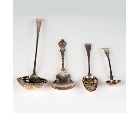 A set of four sterling silver serving pieces, including two exquisite berry spoons, one embellished with molded fruit, and tw