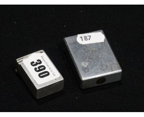A Second World War Aluminium Cigarette Lighter, Engraved With Mickey Mouse Together With A Further Lighter