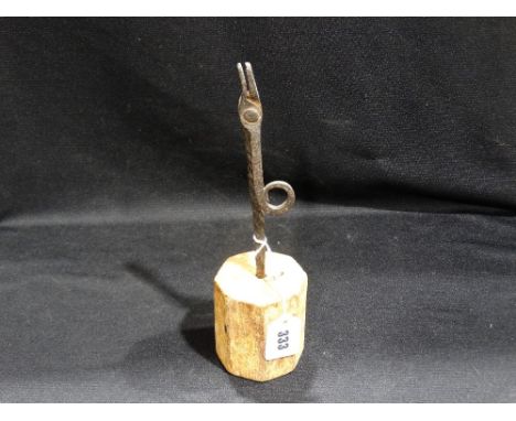 An Antique Wrought Iron Rush Light Holder on A Twist Column And Wooden Base