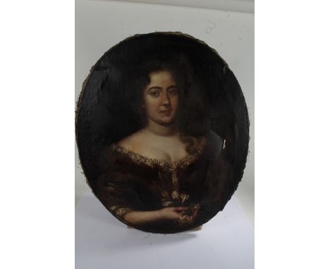 British School, early 18th Century, portrait of a lady wearing a brown velvet dress with lace edging and holding a posy of fl