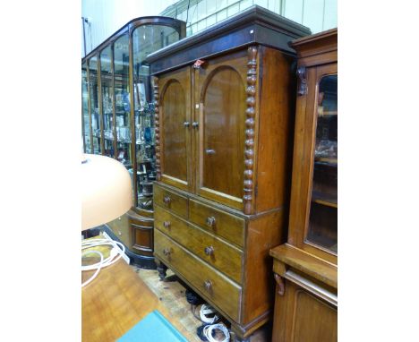 Victorian mahogany linen press having two arched panel doors above a base of four drawers