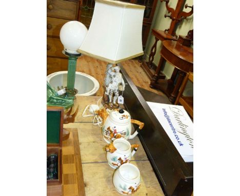 Pottery 'hunting' three-piece tea service and a Continental porcelain figural lamp (4)