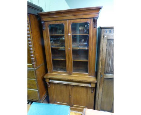 Victorian mahogany cabinet bookcase having two glazed panel doors above a drawer with two cupboard doors below on plinth base