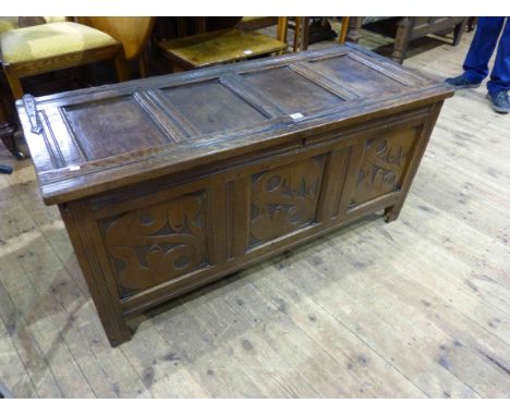 Antique carved oak triple panel front coffer with iron strap hinges and four meat plates