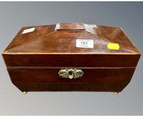 An early 19th century mahogany sarcophagus tea caddy.