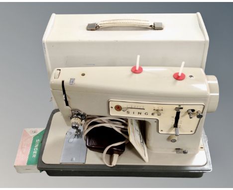 A vintage Singer electric sewing machine with lead and pedal.