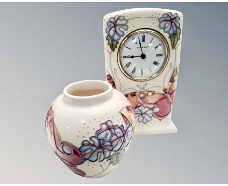 A Moorcroft pottery mantel timepiece (height 16cm), together with a butterfly-patterned globular vase.