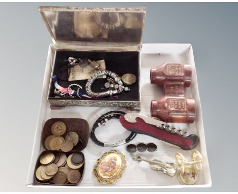 A plated trinket box containing a small quantity of costume jewellery, vintage coins, binoculars, trinkets.